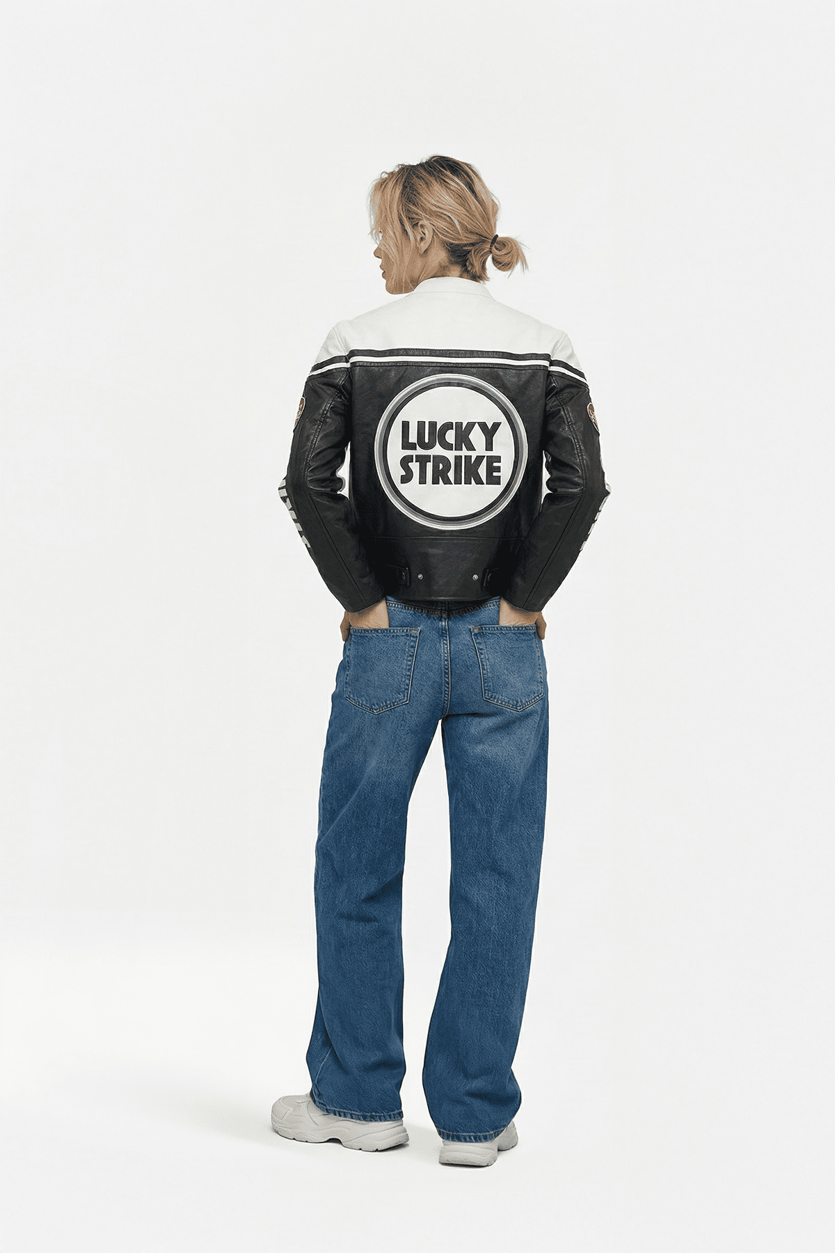 Black and white Lucky Strike racing jacket with bold logo, worn with jeans from revnhaus