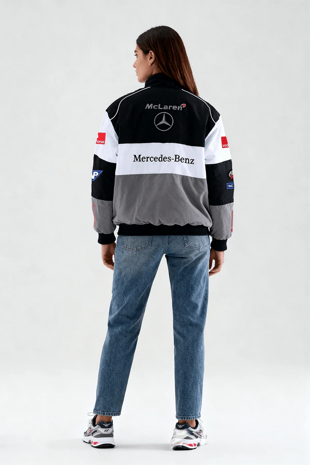 McLaren Mercedes-Benz racing jacket with sponsor logos, worn with jeans and sneakers from revnhaus