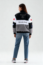 McLaren Mercedes-Benz racing jacket with sponsor logos, worn with jeans and sneakers from revnhaus