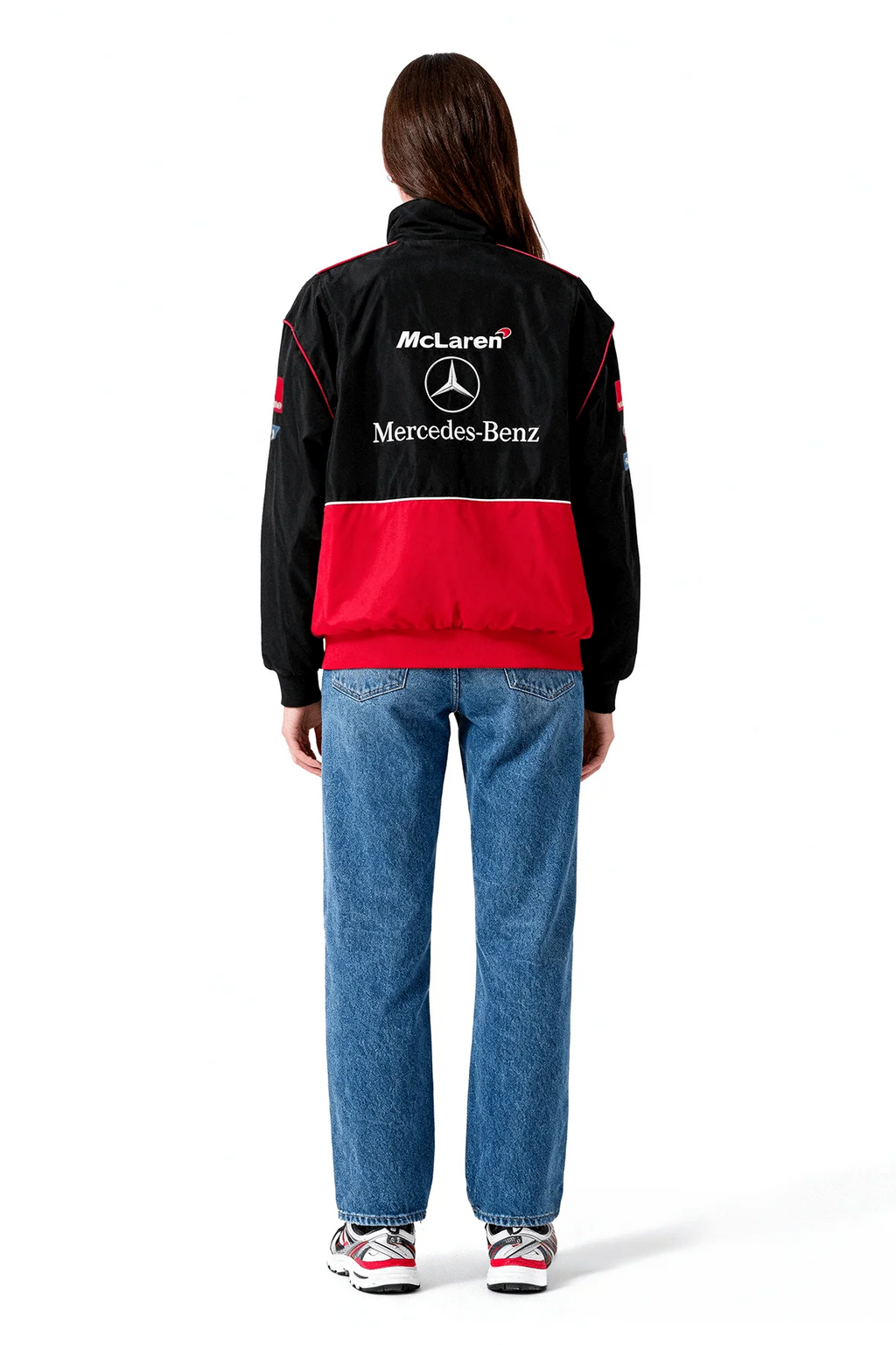 Black and red McLaren Mercedes-Benz racing jacket with logo, worn with jeans from revnhaus