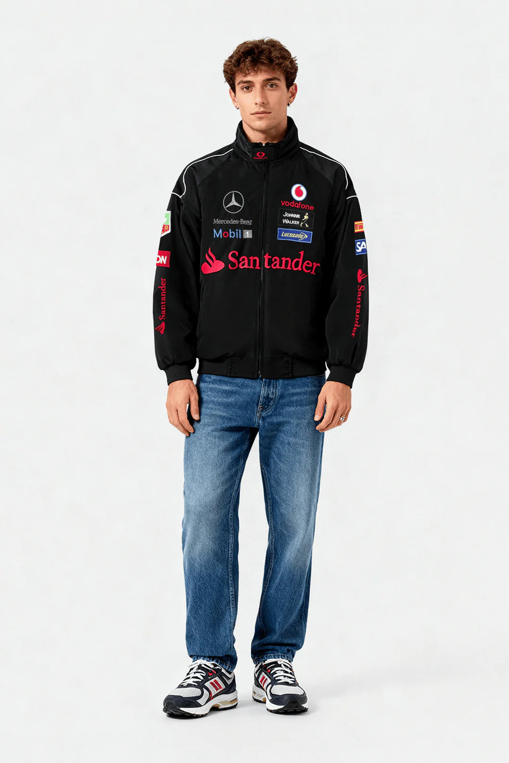 Black racing jacket with Santander, Mercedes-Benz, and Vodafone logos, worn with jeans and sneakers from revnhaus