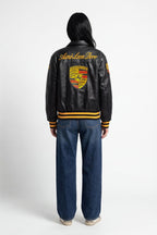 Black Porsche varsity jacket with embroidered crest and Aime Leon Dore logo from revnhaus