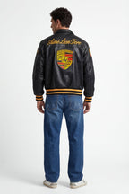 Black Porsche varsity jacket with Aime Leon Dore branding, yellow stripes, from revnhaus