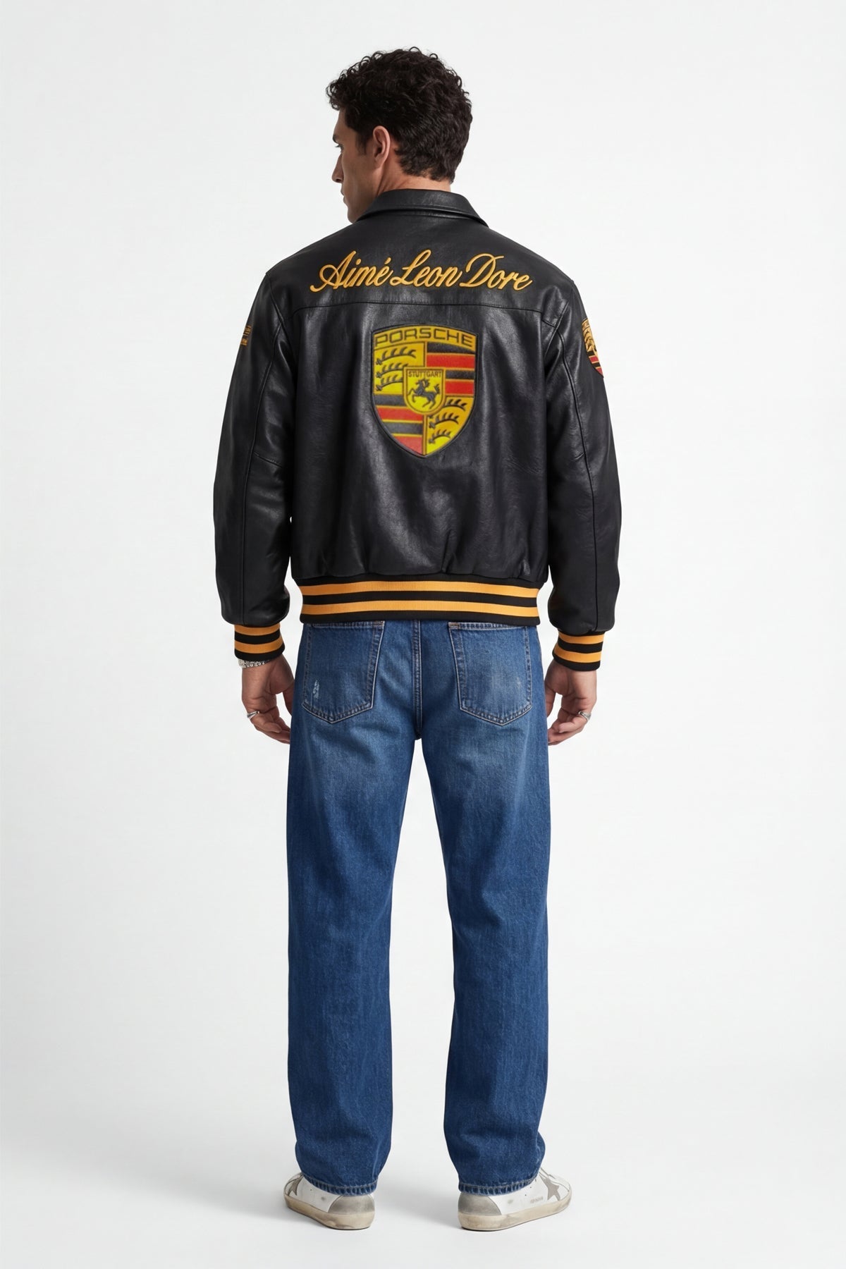 Black Porsche varsity jacket with Aime Leon Dore branding, yellow stripes, from revnhaus