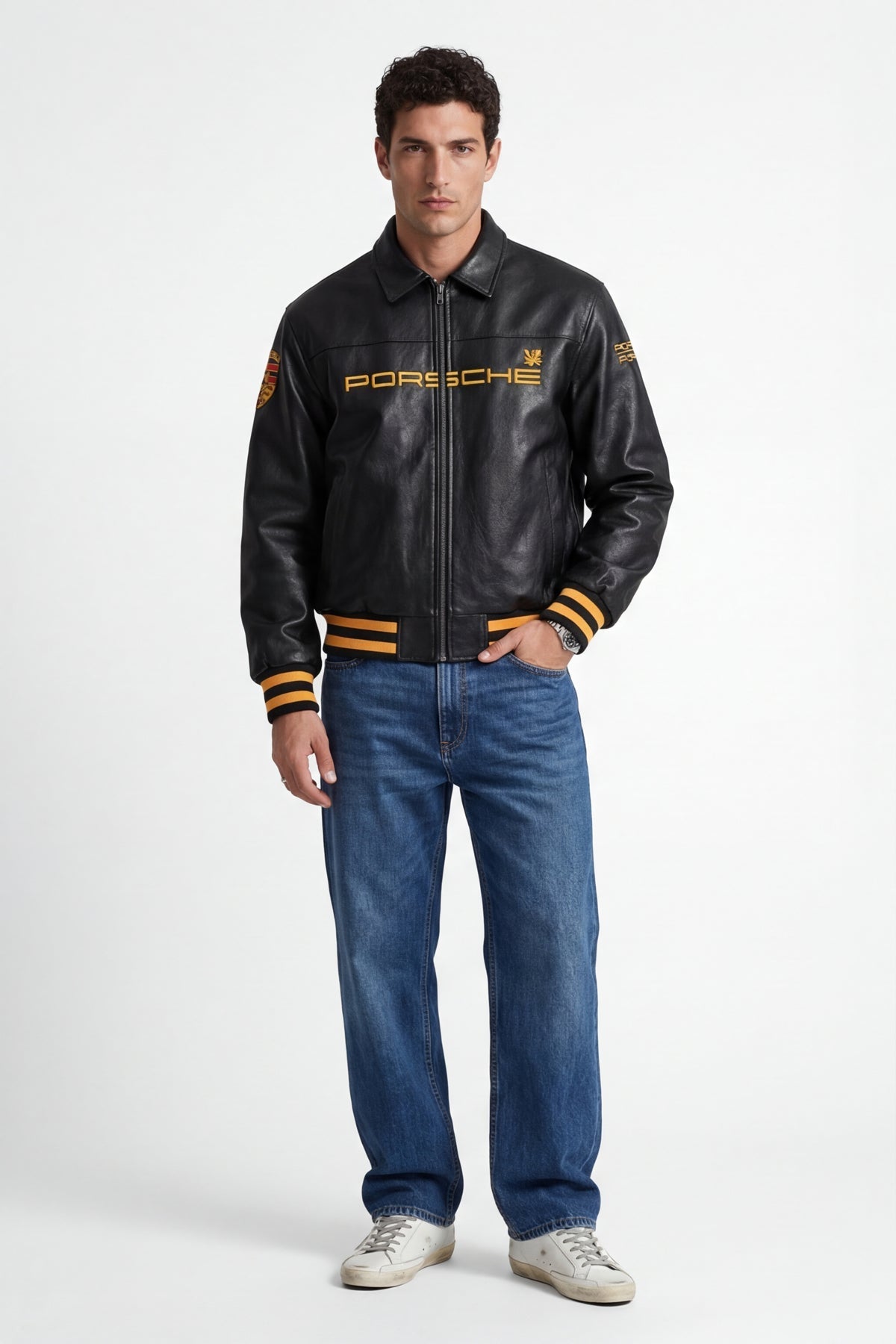 Black Porsche leather racing jacket with gold lettering and stripes, styled with jeans from revnhaus