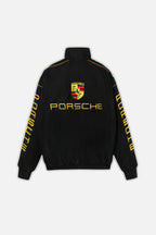 Black Porsche racing jacket with yellow logo and sleeve text from revnhaus