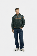 Men's Porsche leather racing jacket with embroidered logo, styled with jeans and sneakers from revnhaus