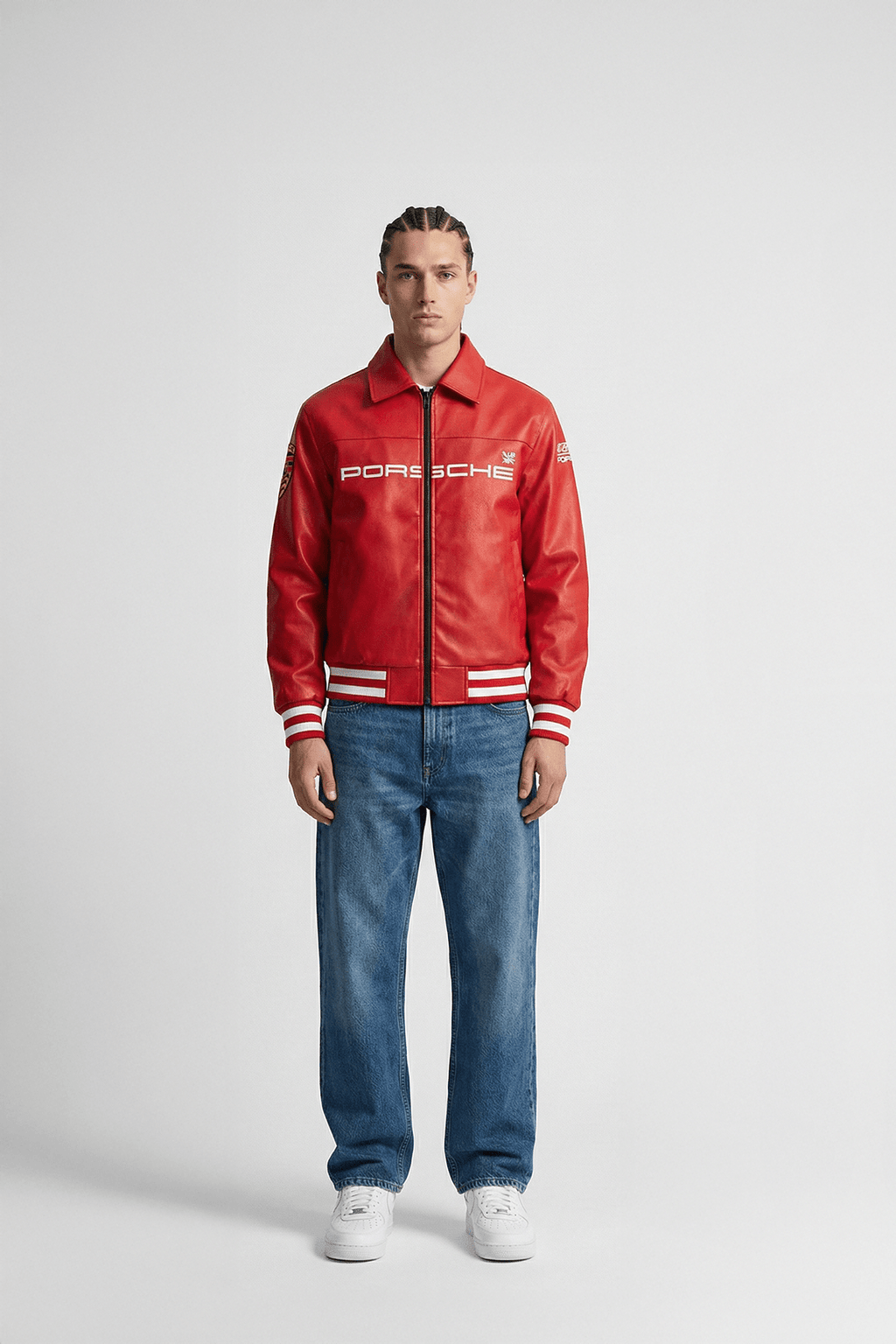 Red Porsche racing jacket with white stripes, worn with jeans and sneakers from revnhaus