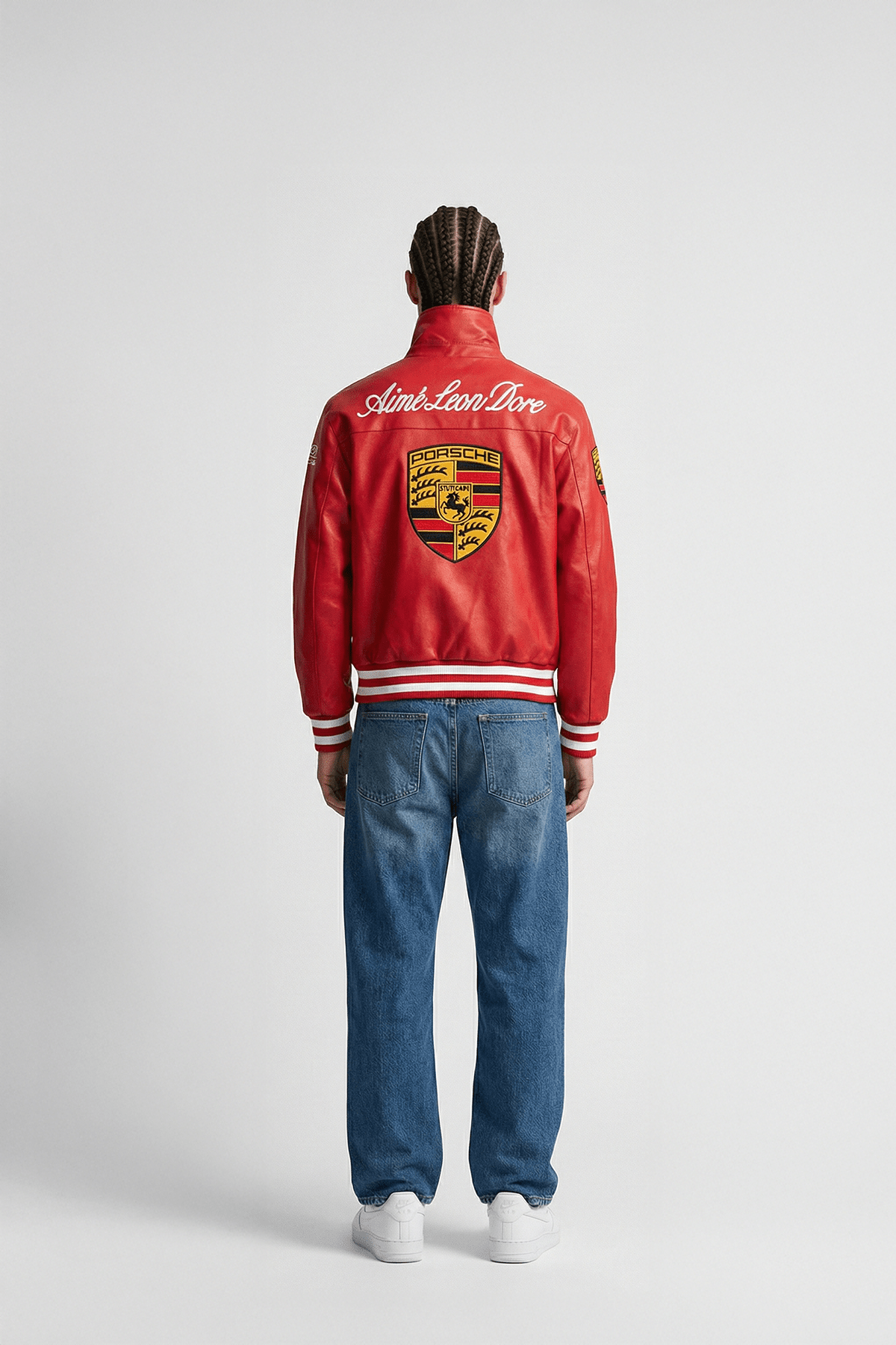 Red Porsche varsity jacket with Aime Leon Dore branding, worn with jeans from revnhaus