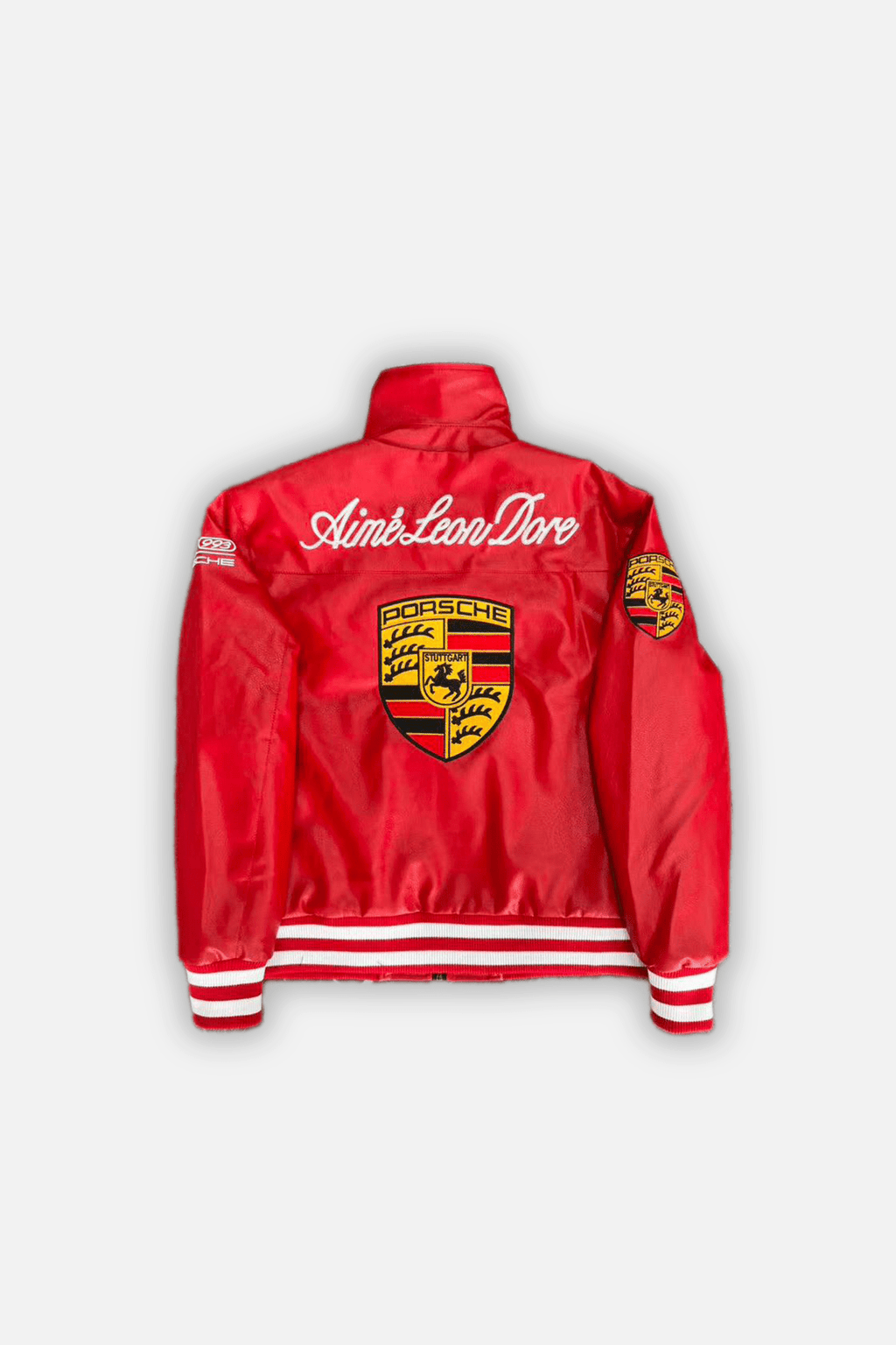 Red Porsche racing jacket with Aime Leon Dore logo and crest, motorsport apparel from revnhaus