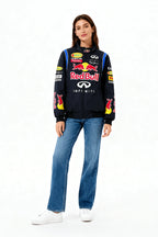 Red Bull Infiniti F1 racing jacket with sponsor logos, worn with jeans and sneakers from revnhaus