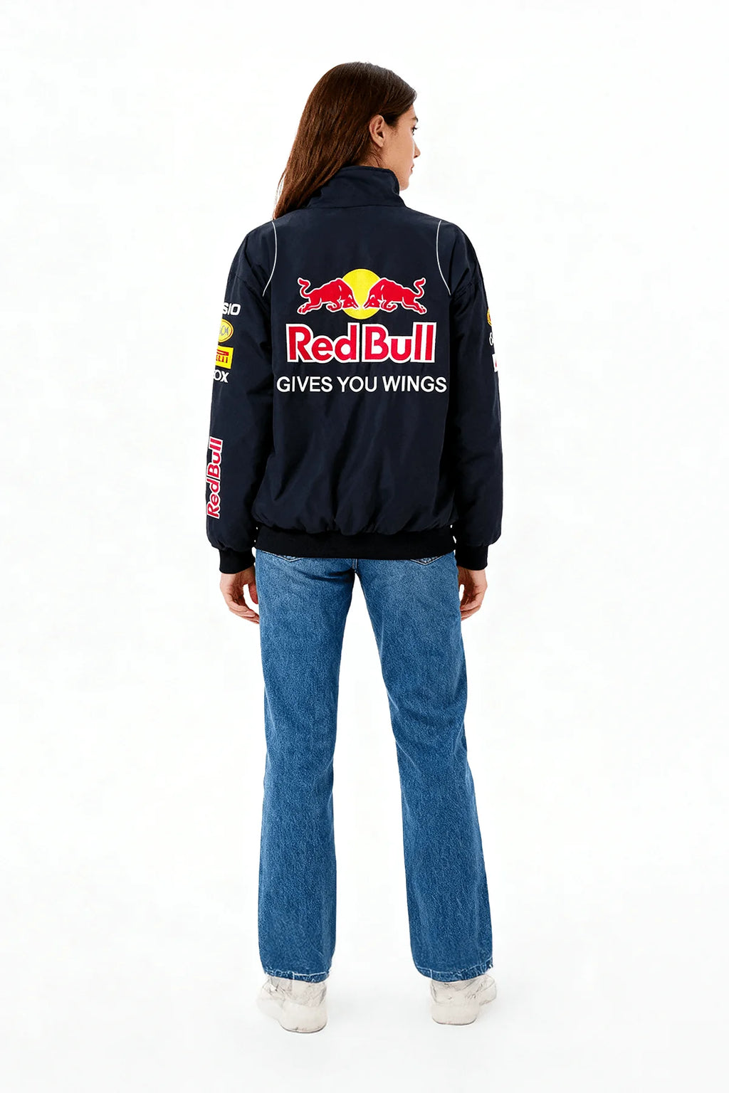 Red Bull racing jacket with 'Gives You Wings' logo on back, worn by woman in jeans from revnhaus