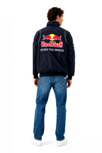 Red Bull racing jacket with 'Gives You Wings' logo on back, worn with jeans from revnhaus