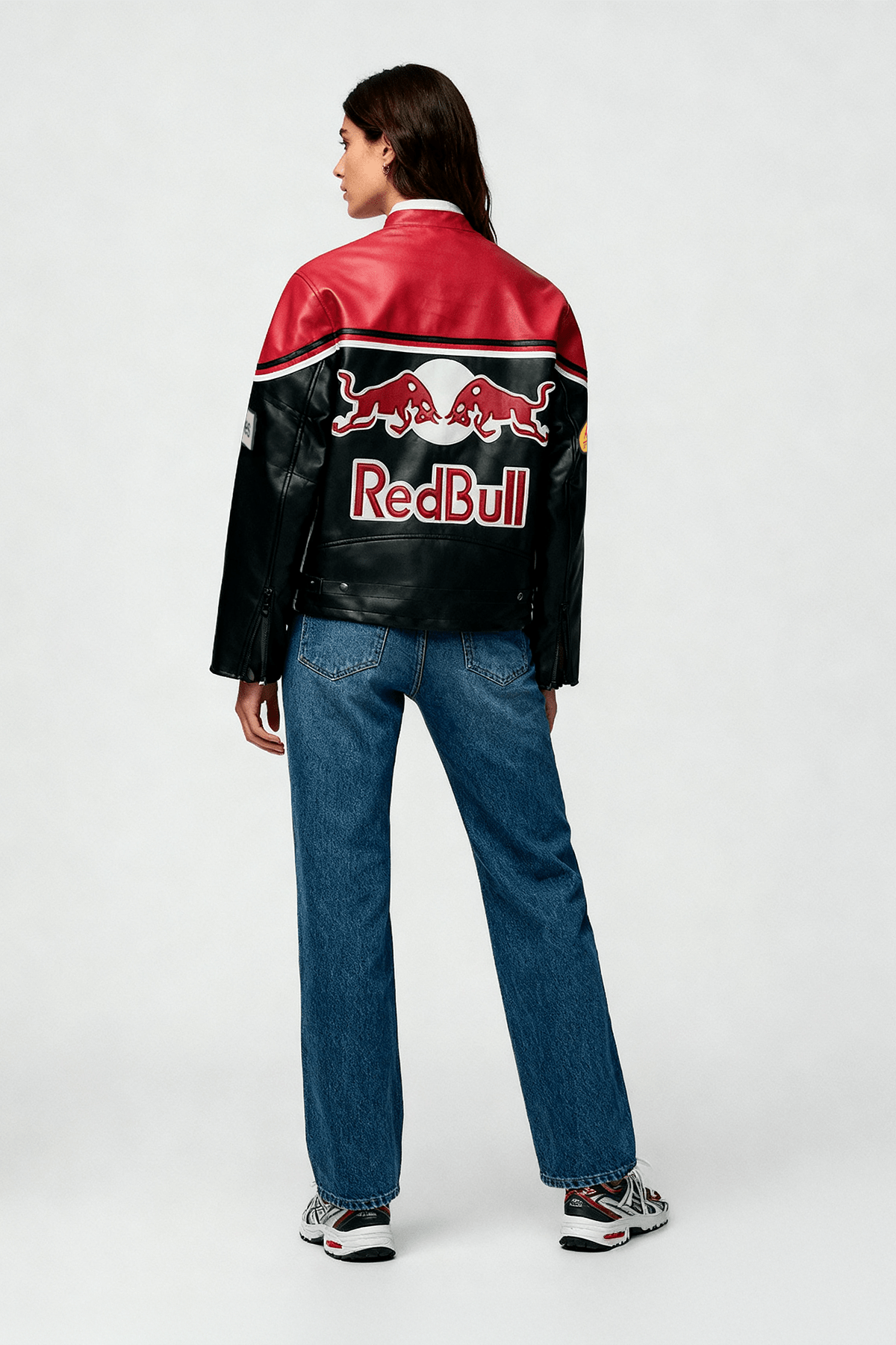 Red Bull racing leather jacket with bold logo, worn with jeans and sneakers from revnhaus