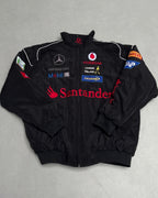 Black F1 racing jacket with Vodafone, Santander, Mercedes-Benz logos from revnhaus