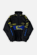Black Subaru World Rally Team jacket with yellow and blue sponsor logos, from revnhaus