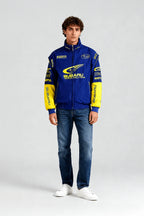 Blue and yellow Subaru World Rally Team racing jacket with Pirelli and Motul logos from revnhaus