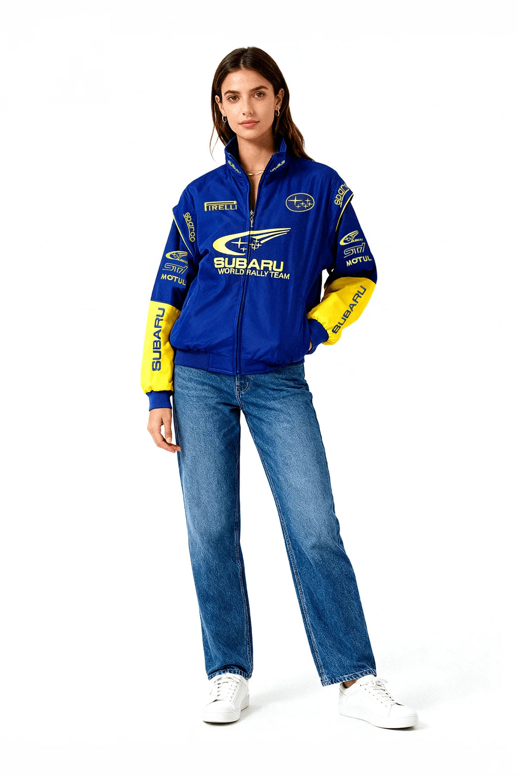 Blue and yellow Subaru World Rally Team racing jacket with sponsor logos, worn with jeans and white sneakers from revnhaus