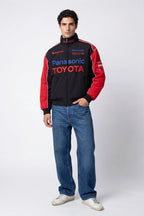 Panasonic Toyota racing jacket with red sleeves and sponsor logos, styled with jeans from revnhaus