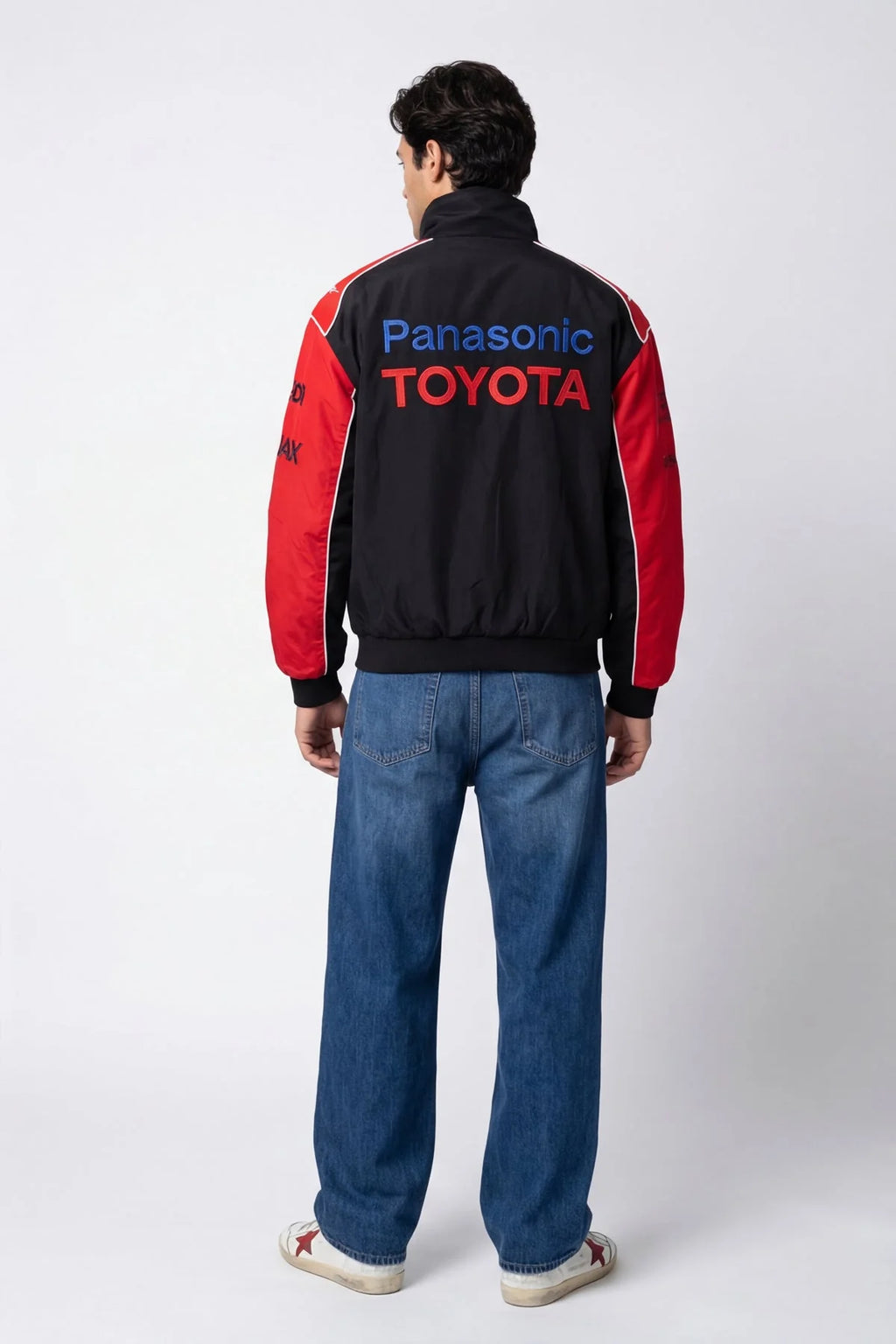 Black and red Panasonic Toyota racing jacket with bold logos, worn with jeans from revnhaus