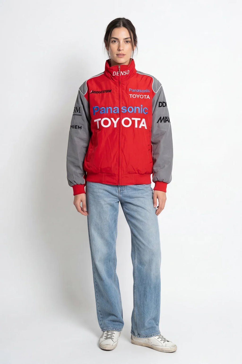 Red and gray Panasonic Toyota racing jacket with sponsor logos, worn with jeans from revnhaus
