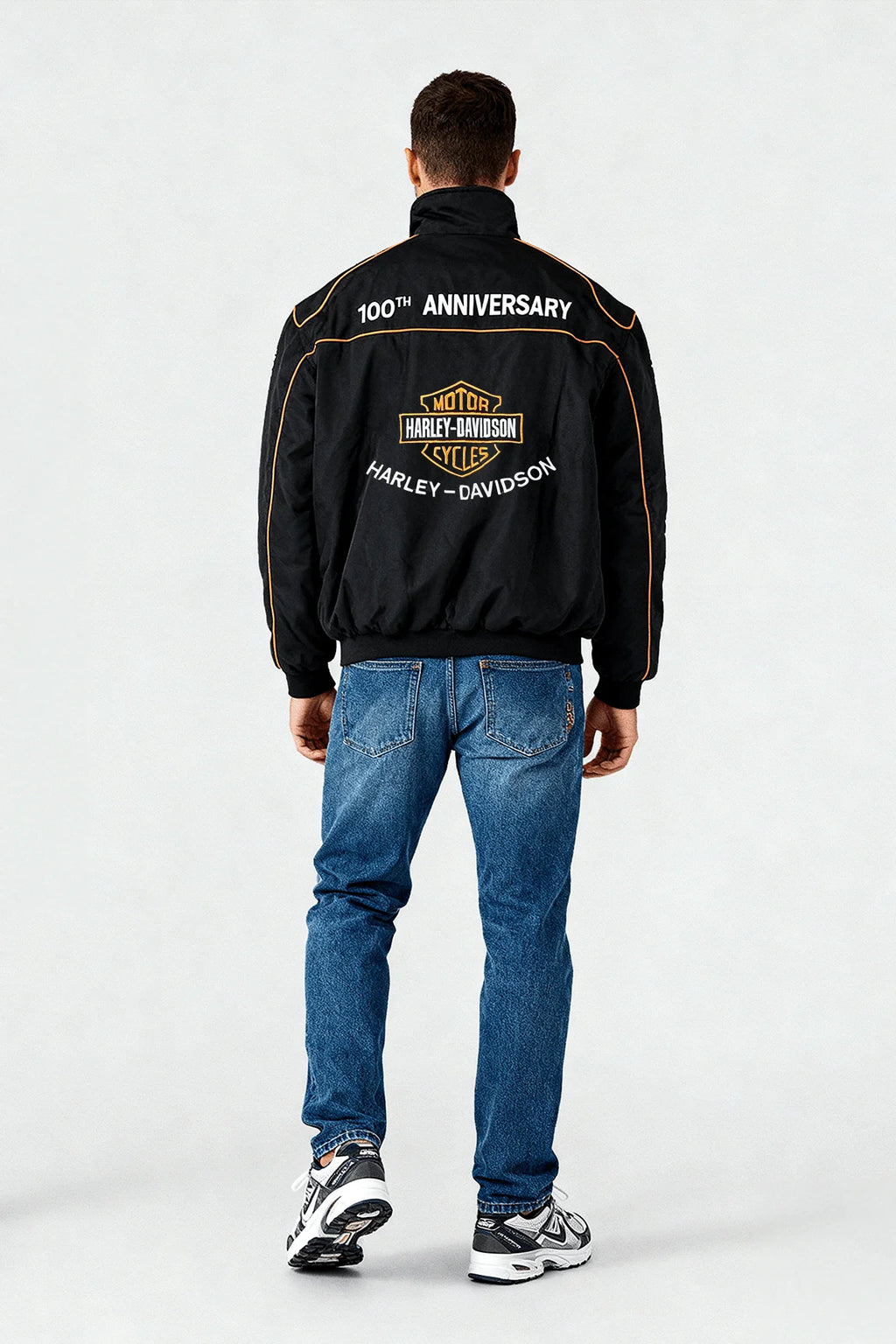 Black Harley-Davidson 100th Anniversary jacket with gold trim, worn with jeans and sneakers from revnhaus