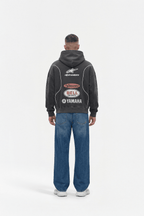 Black motorsport hoodie with Alpinestars, Bell, Yamaha logos, worn with jeans from revnhaus