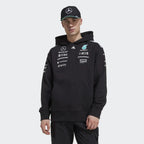 Black Mercedes-AMG F1 team hoodie with sponsor logos and cap, motorsport apparel from revnhaus